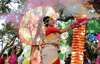 A performer throws coloured powder during Pohela Falgun festivities, at Charukola, Dhaka University, on February 13, 2019 | Syed Zakir Hossain