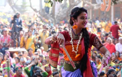 A performer dances in front of a crowd during Pohela Falgun festivities  at Charukola, Dhaka University, on February 13, 2019 | Syed Zakir Hossain nn