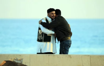 Libyan men exchange Eid al-Fitr greetings at the Libyan port of Benghazi on the eve of June 3, 2019 Reuters