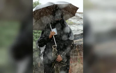 A Rohingya woman holding her ID card walking amidst rain at the Camp No 26, Shalbagan, Teknaf Syed Zakir Hossain/Dhaka Tribune
