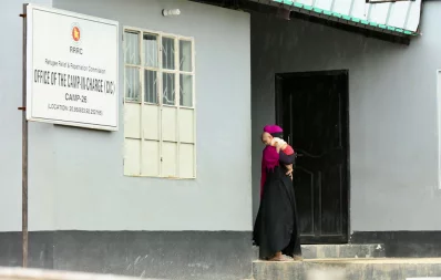 A Rohingya woman with her baby standing outside the office of camp-in-charge of Camp No 26, Shalbagan, Teknaf after appearing for an interview with UNHCR and RRRC representatives Syed Zakir Hossain/Dhaka Tribune