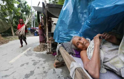 A woman rests on a bed in her shack Syed Zakir Hossain/Dhaka Tribune