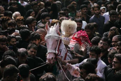 Shiite Muslims walk with a symbolic sacred horse for a good luck, during the religious procession ahead of Ashura, in Lahore, Pakistan, September 9, 2019 |Reuters