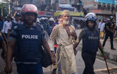 Police taking an elderly Bihari resident resident into custody during the clash at Geneva Camp in Mohammadpur in Dhaka on Saturday, October 5, 2019 Mahmud Hossain Opu/ Dhaka Tribune