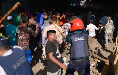 Police officials trying to disperse a crowd of agitated Bihari residents using baton charge in Mohammadpur Geneva camp in Dhaka on October 5, 2019 Mahmud Hosain Opu