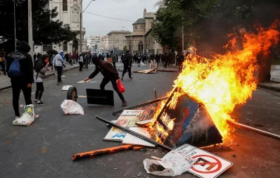 Demonstrators set fire to street signs and other objects during a protest against the government in Valparaiso, Chile on October 19, 2019 /Reuters