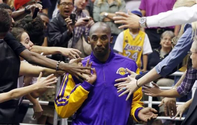 Kobe Bryant walks past fans before the second half of the Lakers game against the Utah Jazz in Salt Lake City, Utah on November 7, 2012 Reuters