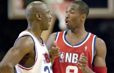Washington Wizards Michael Jordan and Lakers Kobe Bryant chat during the second half of the NBA All-Star game in Atlanta, February 9, 2003 Reuters