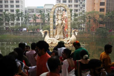Devotees in front a statue of Swaraswati at Dhaka Universitys Jagannath Hall pond | Mehedi Hasan/Dhaka Tribune