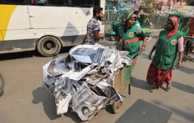 A city corporation worker takes away election posters, used in Dhaka city polls, on February 2, 2020 | Rajib Dhar/Dhaka Tribune
