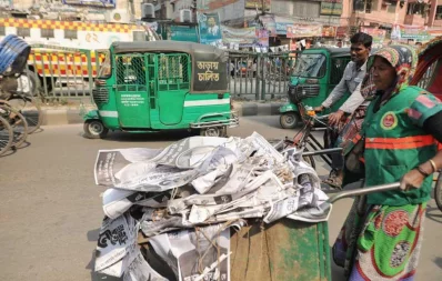 A city corporation worker takes away election posters, used in Dhaka city polls, on February 2, 2020 | Rajib Dhar/Dhaka Tribune