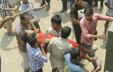 Locals carrying a victim of the Rana Plaza accident after rescuing her Syed Zakir Hossain/Dhaka Tribune