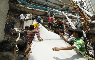 A female worker being slide down on a cloth from top of the collapsed building as part of the rescue work Syed Zakir Hossain/Dhaka Tribune