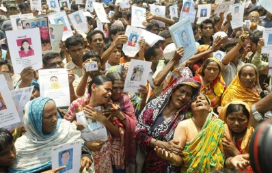Family members break into tears as they hold up portraits of missing relatives from the Rana Plaza building collapse Syed Zakir Hossain/Dhaka Tribune