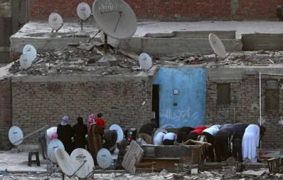 Egyptians perform Eid al-Fitr prayers, marking the end of the holy fasting month of Ramadan, on the roof of thier house, after mosques were shut amid concerns about the spread of the coronavirus disease (COVID-19), in Cairo, Egypt, May 24, 2020 Reuters