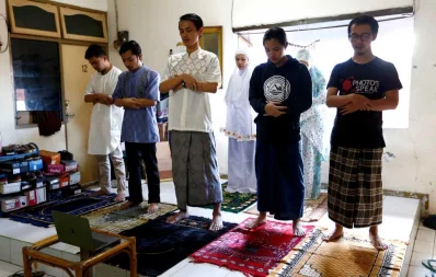 Indonesian Muslims take part in prayers during Eid al-Fitr, the Muslim festival marking the end the holy fasting month of Ramadan, at a boarding house in Jakarta, Indonesia, amid the coronavirus disease (COVID-19) outbreak May 24, 2020 Reuters