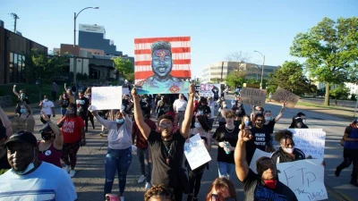 A man holds a sign with a target as he joins other protesters during a protest against the death in Minneapolis police custody of African-American man George Floyd, in St Louis, Missouri, US May 29, 2020nReuters