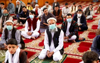Afghan men take part in prayers during Eid al-Fitr, the Muslim festival marking the end the holy fasting month of Ramadan, at a mosque amid the spread of the coronavirus disease (COVID-19), in Kabul, Afghanistan May 24, 2020 Reuters