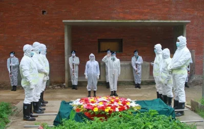 A team of Bangladesh Police give a guard of honour to Prof Anisuzzaman before his burial at Azimpur graveyard in Dhaka on Friday, April 15, 2020 UNBn