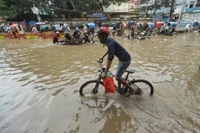 A man wades through rainwater as he rides his bicycle at Green Road area in Dhaka on Monday, July 20, 2020 | Rajib Dhar/Dhaka Tribune