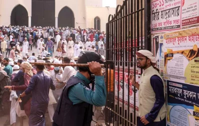 A police member and a protester face off during hardliner Islamists protest against installation of sculptures, near Baitul Mukarram National Mosque in Dhaka on Friday, December 2020 Mahmud Hossain Opu/Dhaka Tribune