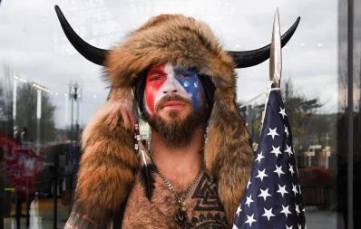 A man with his face painted in the colors of the US flag poses for a picture as supporters of US President Donald Trump gather (not pictured) in Washington, US January 6, 2021 Reuters