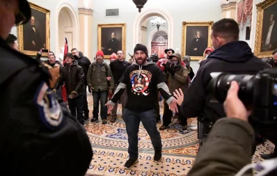 A supporter of President Donald Trump confronts police as Trump supporters demonstrate on the second floor of the US Capitol near the entrance to the Senate after breaching security defenses, in Washington, US, January 6, 2021 Reuters