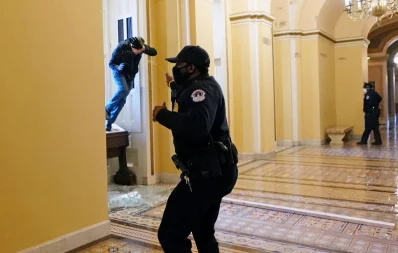A US Capitol police officer shoots pepper spray at a protestor attempting to enter the Capitol building during a joint session of Congress to certify the 2020 election results on Capitol Hill in Washington, US, January 6, 2021 Reuters