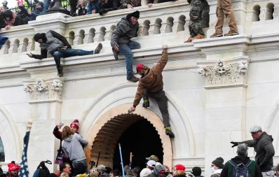 Supporters of US President Donald Trump climb on walls at the US Capitol during a protest against the certification of the 2020 US presidential election results by the US Congress, in Washington, US, January 6, 2021 Reuters
