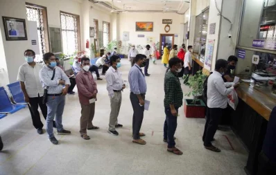 Customers stand in a queue at a bank in Dhaka on the first day of the week-long lockdown on Monday. During the lockdown, banks will remain open for only 2.5 hours on weekdays Mehedi Hasan/Dhaka Tribune