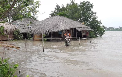 Chalna Gorkhali area was inundated tidal surge, triggered by Cyclone Yaas.  Saira Begum goes to a safe place with her son and a goat. The photo taken from Dakop upazila under Khulna District Photo courtesy:Habibur Rahman