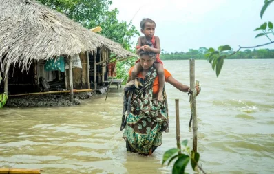 Chalna Gorkhali area was inundated tidal surge, triggered by Cyclone Yaas.  Saira Begum goes to a safe place with her son and a goat. The photo taken from Dakop upazila under Khulna District Photo courtesy:Habibur Rahman