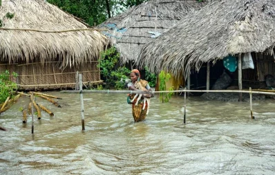 Chalna Gorkhali area was inundated tidal surge, triggered by Cyclone Yaas.  Saira Begum goes to a safe place with her son and a goat. The photo taken from Dakop upazila under Khulna District Photo courtesy:Habibur Rahman