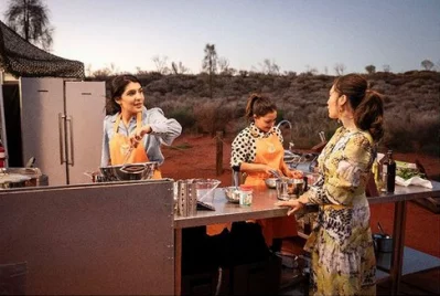 Kishwar and Depinder cook in front of the Field of Lights at Uluru