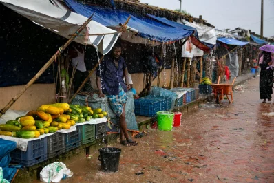 Vendors sit in the rain as they wait for customers at a Rohingya refugee camp in Coxs Bazar, Bangladesh, on Wednesday, August 11, 2021 Allison Joyce/Dhaka Tribune