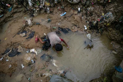 nA child plays in a puddle during a rainstorm at a Rohingya refugee camp in Coxs Bazar, Bangladesh, on Wednesday, August 11, 2021 Allison Joyce/Dhaka Tribunen