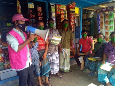 BRAC volunteer spreading COVID-19 awareness messages in a local hut by through mikingn
