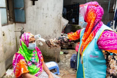 A BRAC Shasthya Kormi screening a potentially infected individual for symptoms during household visit as a part of syndromic surveillancen