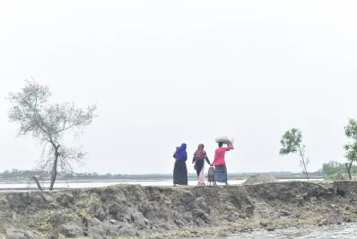 Cyclone Amphan - This picture was taken at noon at Bonnotola, Padmapukur after Amphan. The people are sitting on the dam as their houses are mostly washed away with the tidal water. Unaware of how they will manage their next meal, they sit there with lots of tension and anxiety about what is going to happen next.