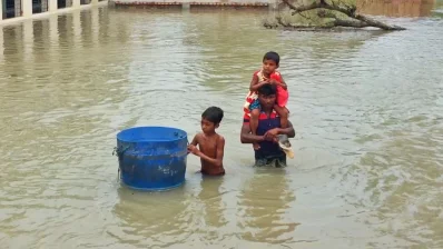 Cyclone YAAS - This picture was taken right after cyclone YAAS when a father was taking his children to their home. They spent the night at the local mosque as the water rose. The father is taking the younger child on his shoulder as she cant swim, and the elder one is taking his pets (ducks and chicken) in the drum. Both the father and the son are trying to protect their loved ones.