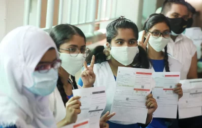 Students hold up their vaccination cards at the Ideal School and College centre where inoculation school students aged 12-17 took off on Monday, November 1, 2021 Mehedi Hasan/Dhaka Tribune