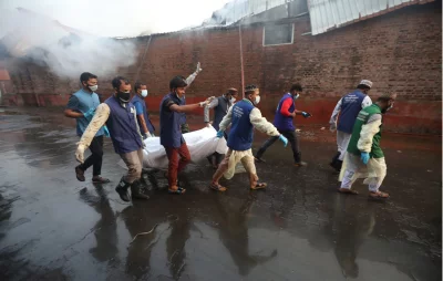 A body is being carried away from BM Container Depot following a fire, Sunday, June 5, 2022 Dhaka Tribune
