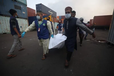 A body is being carried away from BM Container Depot following a fire, Sunday, June 5, 2022 Dhaka Tribune
