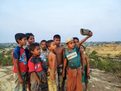 A group of children take a selfie using a sandal on a hilltop in Balukhali camp Ro Yassin Abdumonab 2022