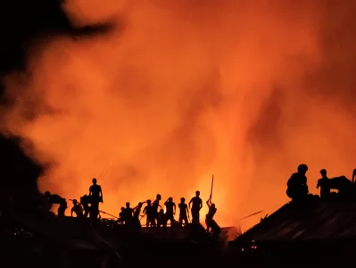 Fire in the Sky. Refugees trying to extinguish the flames of a fire in the refugee camp. The big fire that occurred in the camps on 22 March 2021 left 50,000 refugees homeless. This image portrays the efforts made by those affected to extinguish the flames in the area where the fire took place Sahat Zia Hero 2021