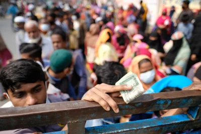 People wait in line to buy cooking oil from a mobile truck of the Trading Corporation of Bangladesh (TCB) in the Azimpur area in Dhaka. Photo: Mahmud Hossain Opu/Dhaka Tribune