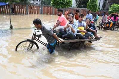 Some passengers are seen commuting in a van through waist-deep water in Dhaka, on Friday, September 22, 2023. Mahmud Hossain Opu/Dhaka Tribune