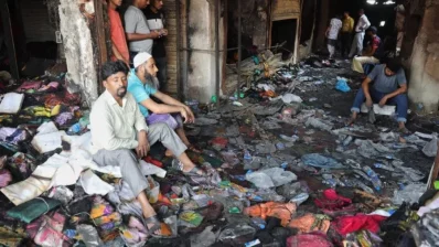 This file image shows traders sitting on heaps of clothes ruined in a fire at New Supermarket in Dhaka in April this year. Photo: Dhaka Tribune