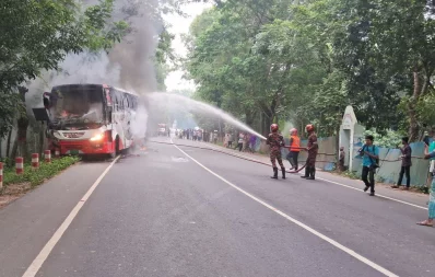 The image shows firefighters working to bring the blaze on the bus under control after it killed two people in Gopalganj on Friday, September 29, 2023. Photo: Dhaka Tribune
