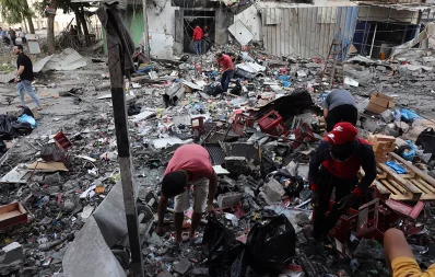 Palestinians search the rubble for salvageable items following overnight Israeli airstrikes in Gaza City on October 11, 2023, on the fith day of battles between Israel and the Hamas movement. Photo: AFP